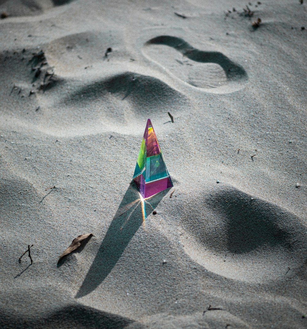 green and white umbrella on gray sand