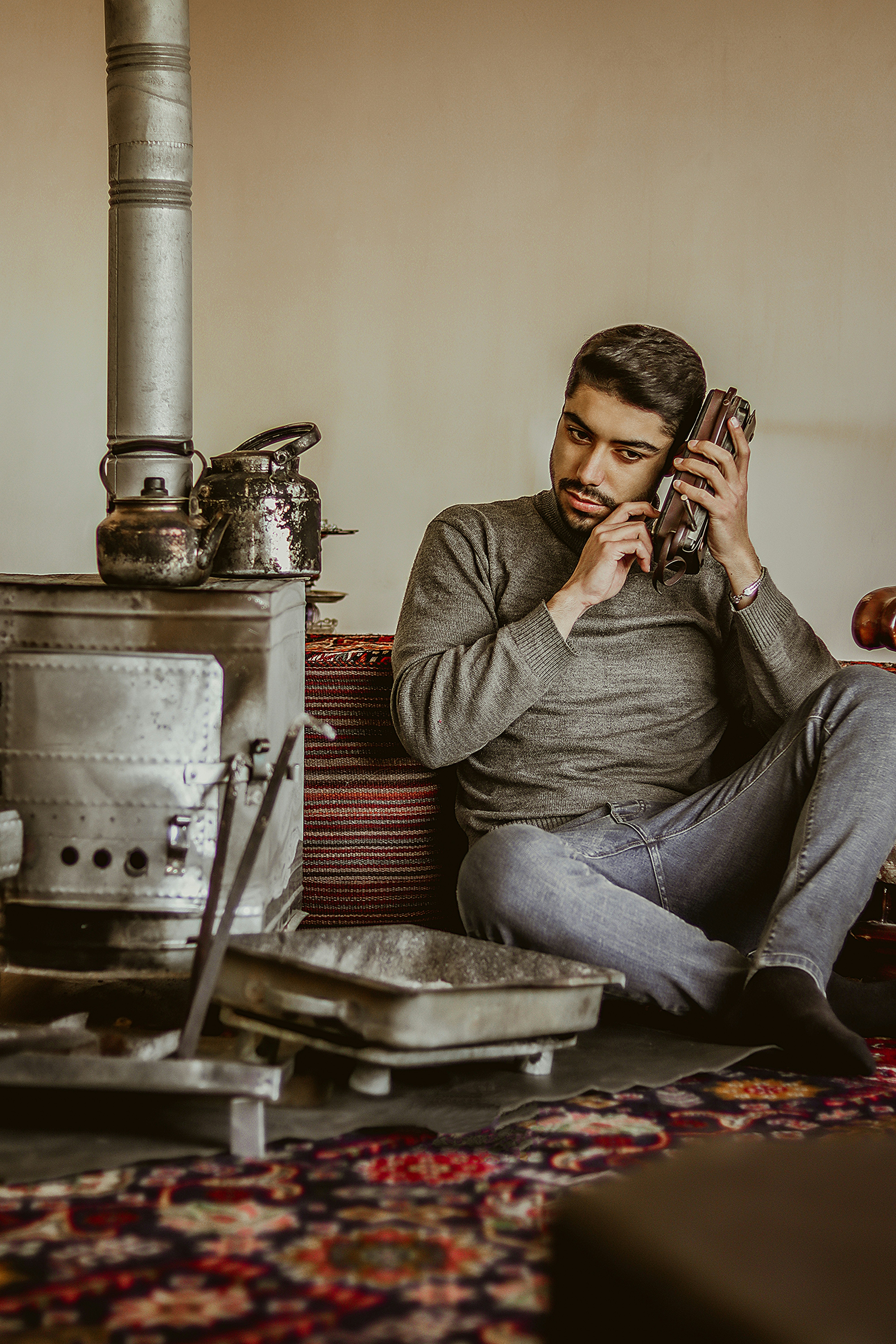 man in gray long sleeve shirt sitting on chair