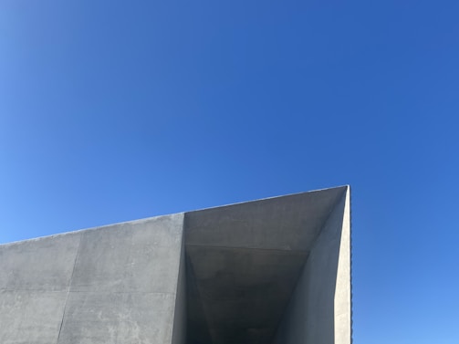 Modern concrete structure featuring clean lines under a bright sky.