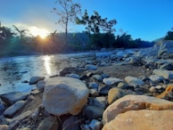 Sunset over a river where habitat conservation efforts are in progress.