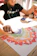 A joyful child crafting with natural materials like leaves and pinecones in a bright workshop.