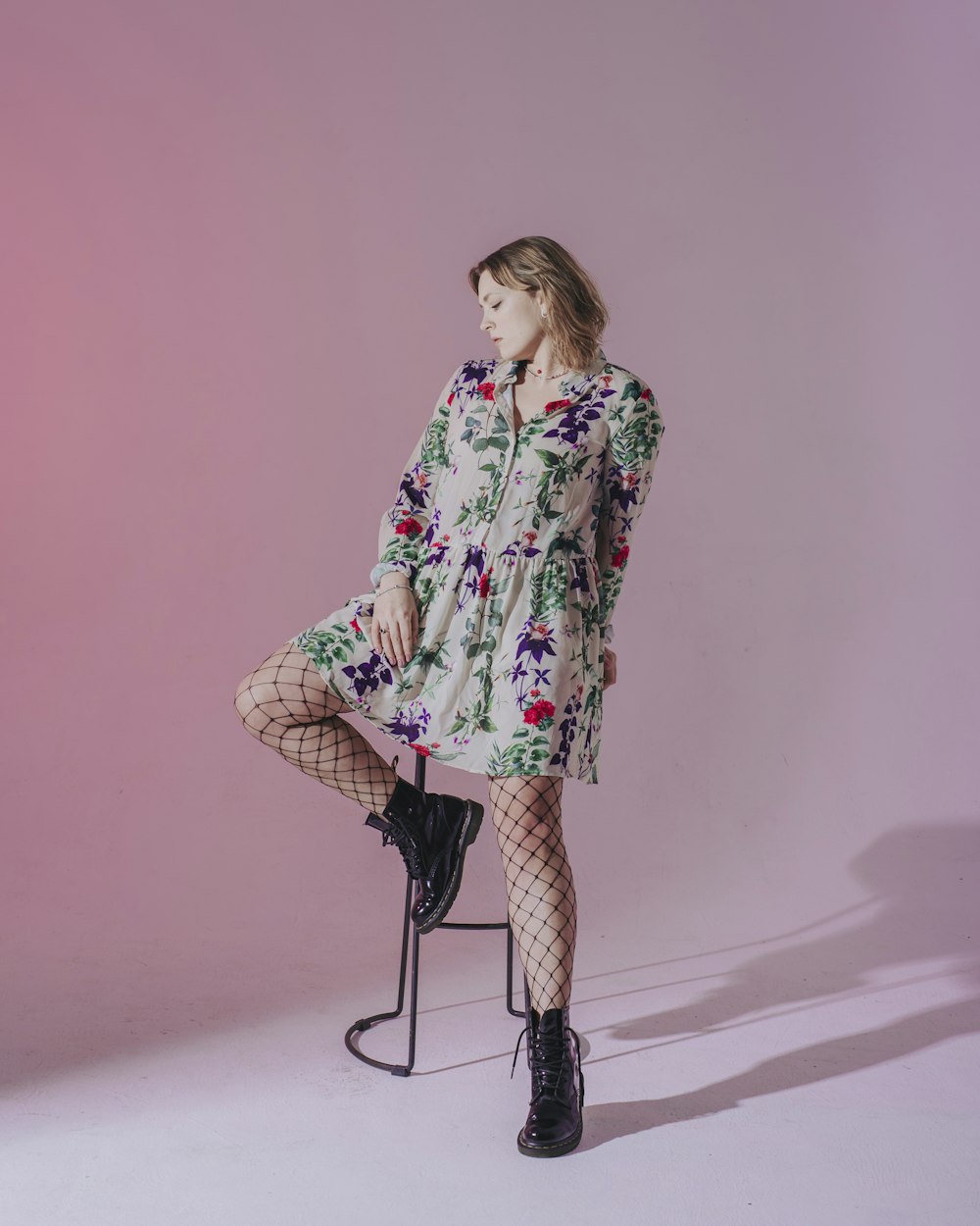 woman in white red and green floral long sleeve shirt standing