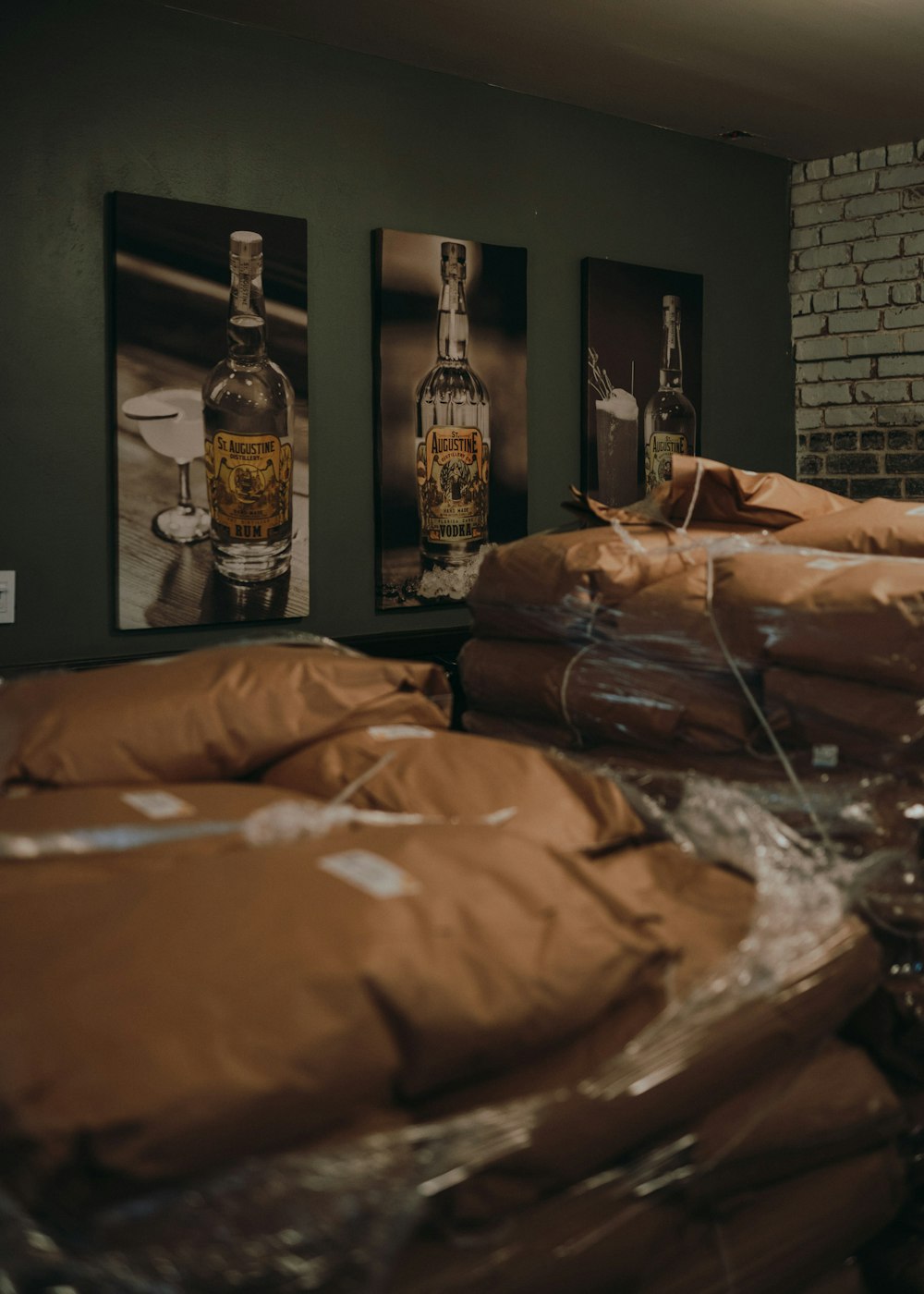 clear glass bottle beside brown paper bag