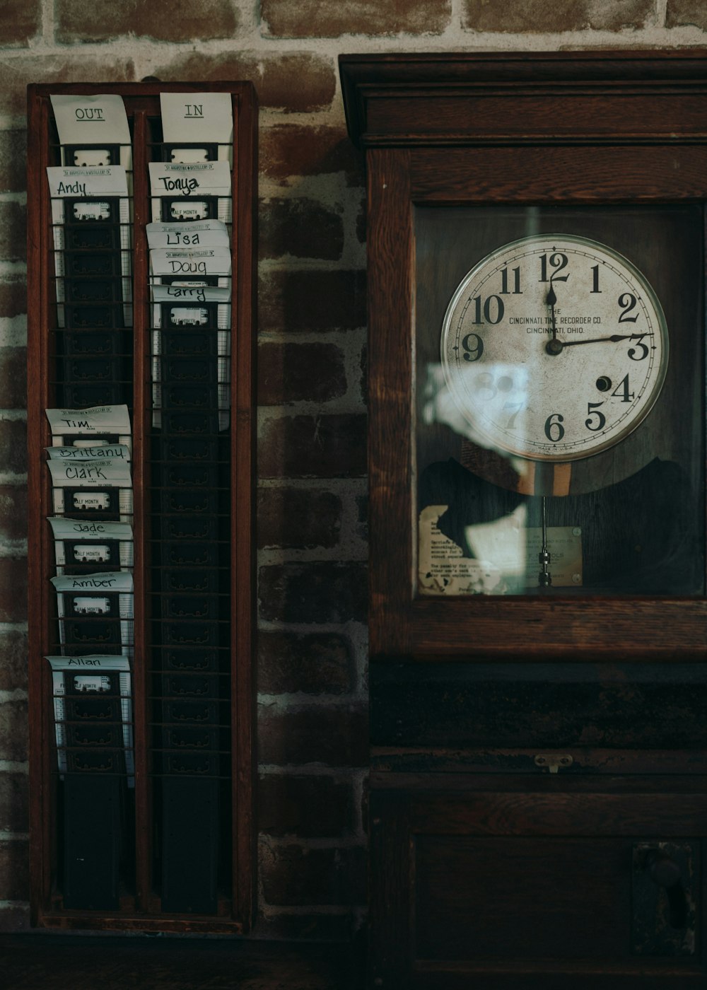 brown wooden framed analog wall clock at 10 00