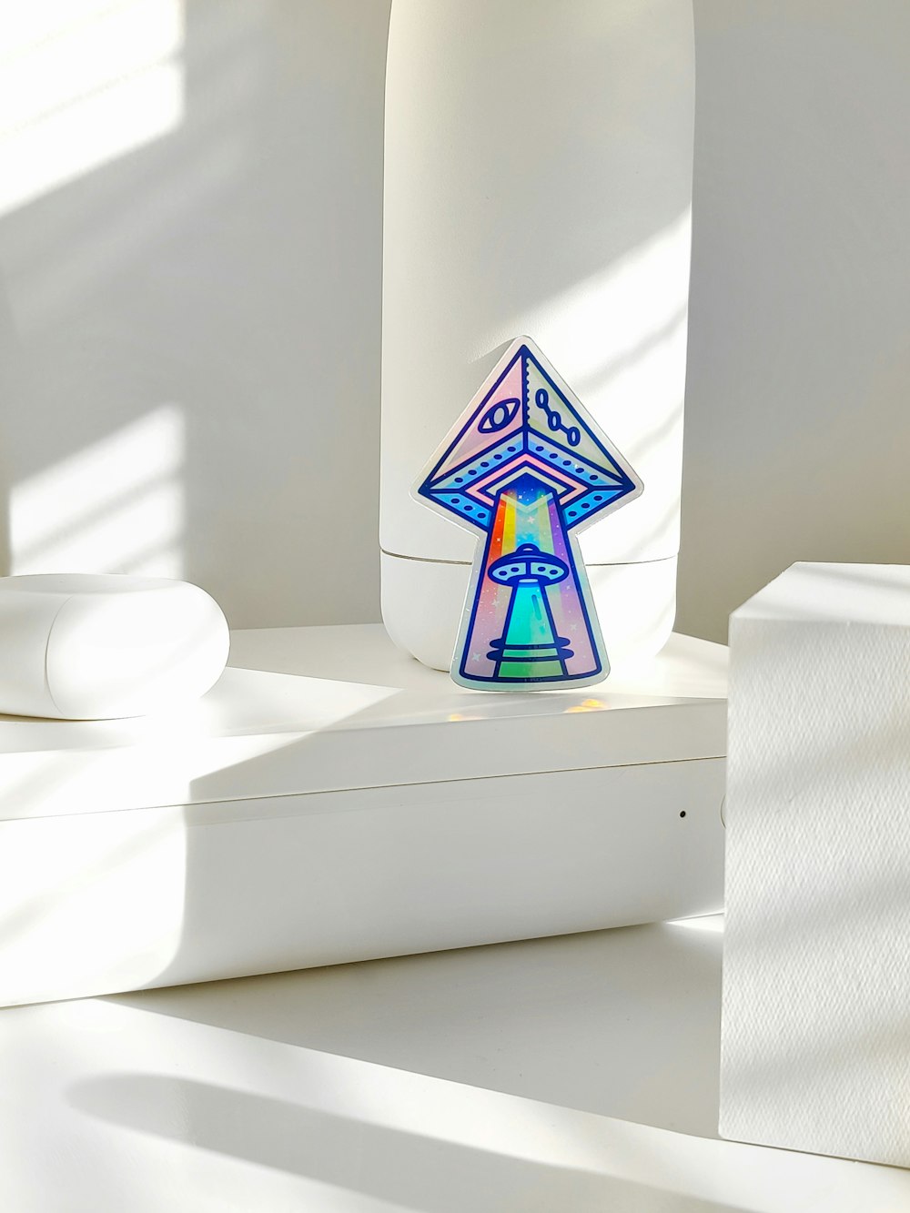 white blue and yellow pyramid ceramic figurine