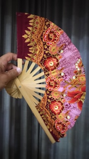Close-up of a colorful handwoven Ivorian fan with intricate patterns