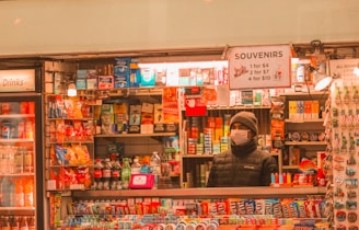 woman in black jacket standing in front of store
