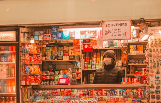 woman in black jacket standing in front of store