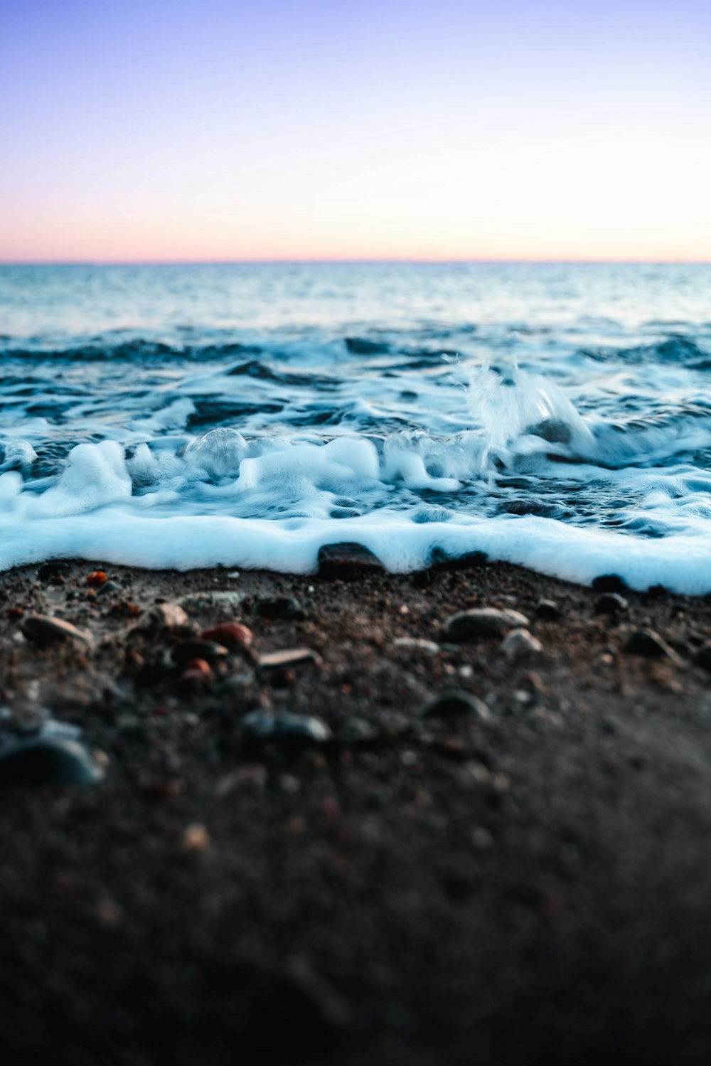 sea waves on brown sand during daytime