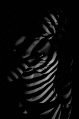 A black and white artistic photo highlighting the contrast of light and shadow in media production.