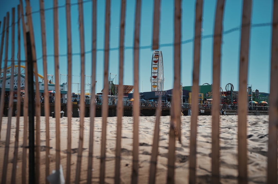 brown metal fence near blue and white building during daytime