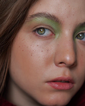 Square image of a close-up on a woman's eye with natural makeup and glowing skin.