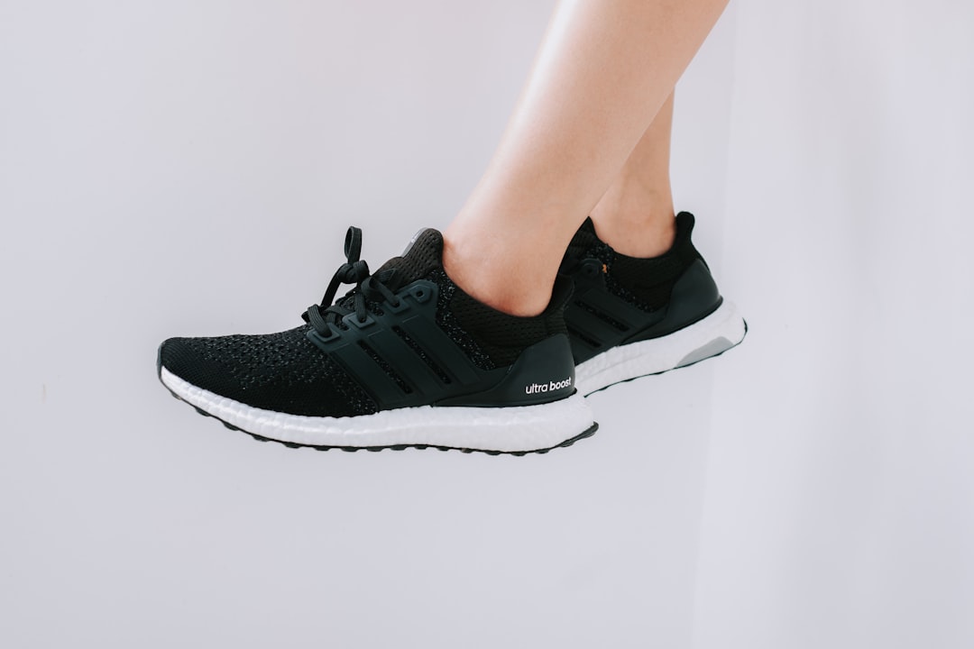person wearing black and white nike athletic shoes, Adidas Ultraboost