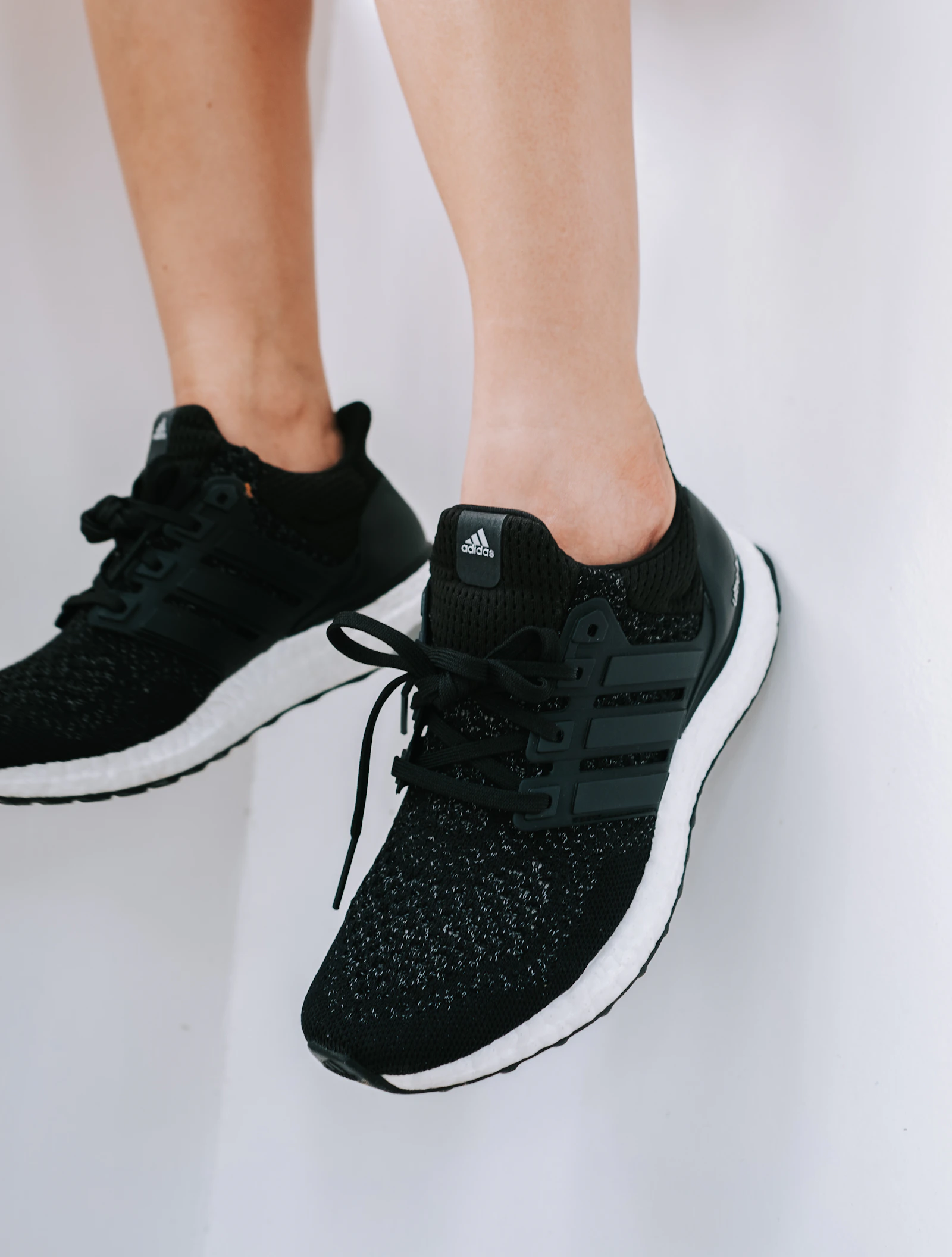Black Adidas Ultraboost on feet