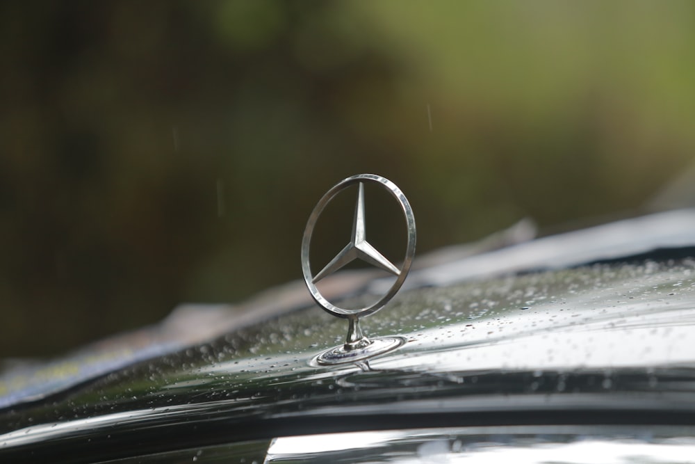 silver mercedes benz emblem on car