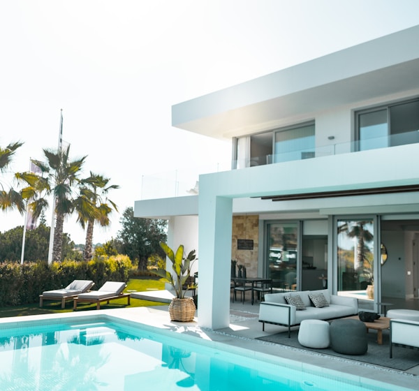 white concrete building with swimming pool