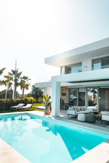 A simple modern Bangalow with swimming pool and green landscape.