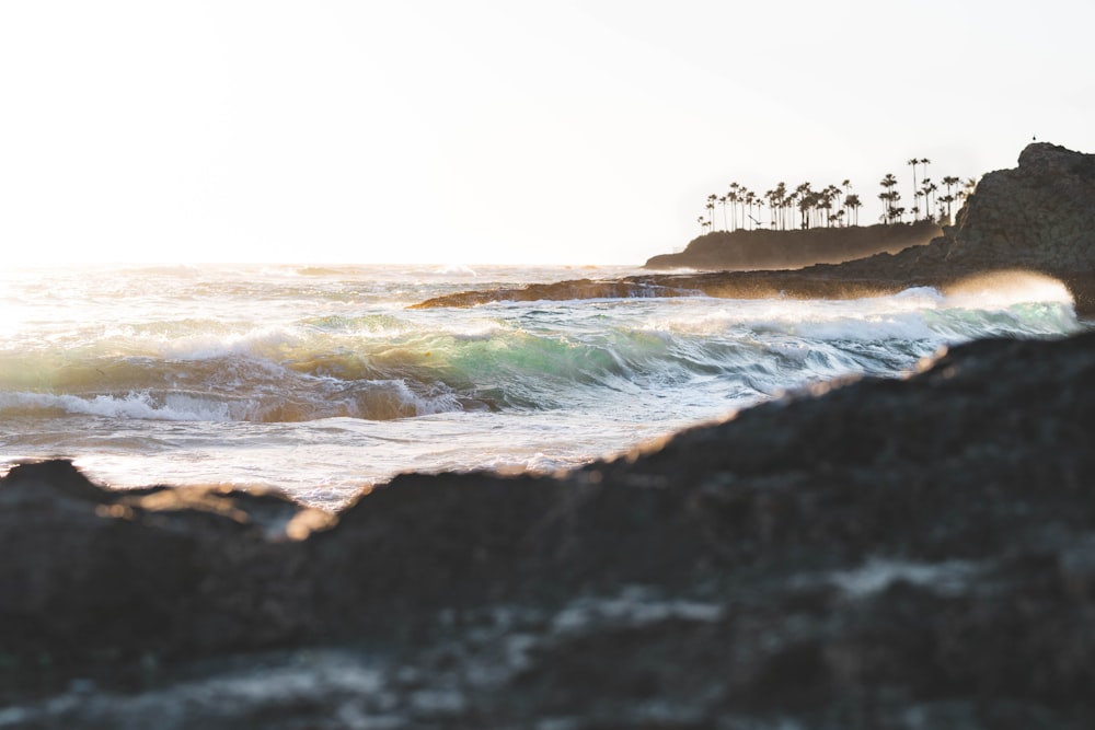 ocean waves crashing on shore during daytime