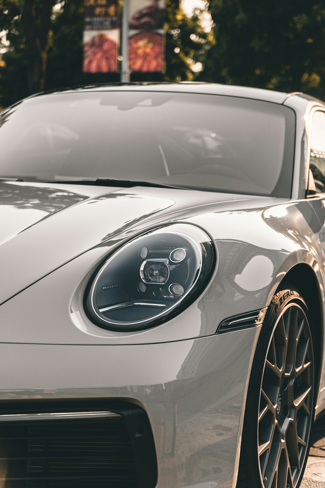 white porsche 911 parked on gray pavement