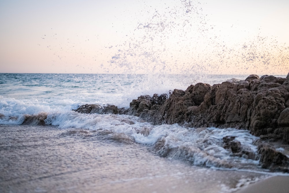 brown rock formation on sea during daytime