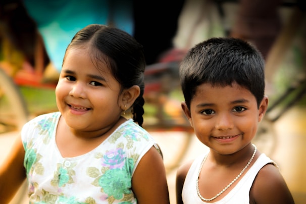 A candid moment of Allen children playing together in a sunlit park, their smiles wide and carefree.