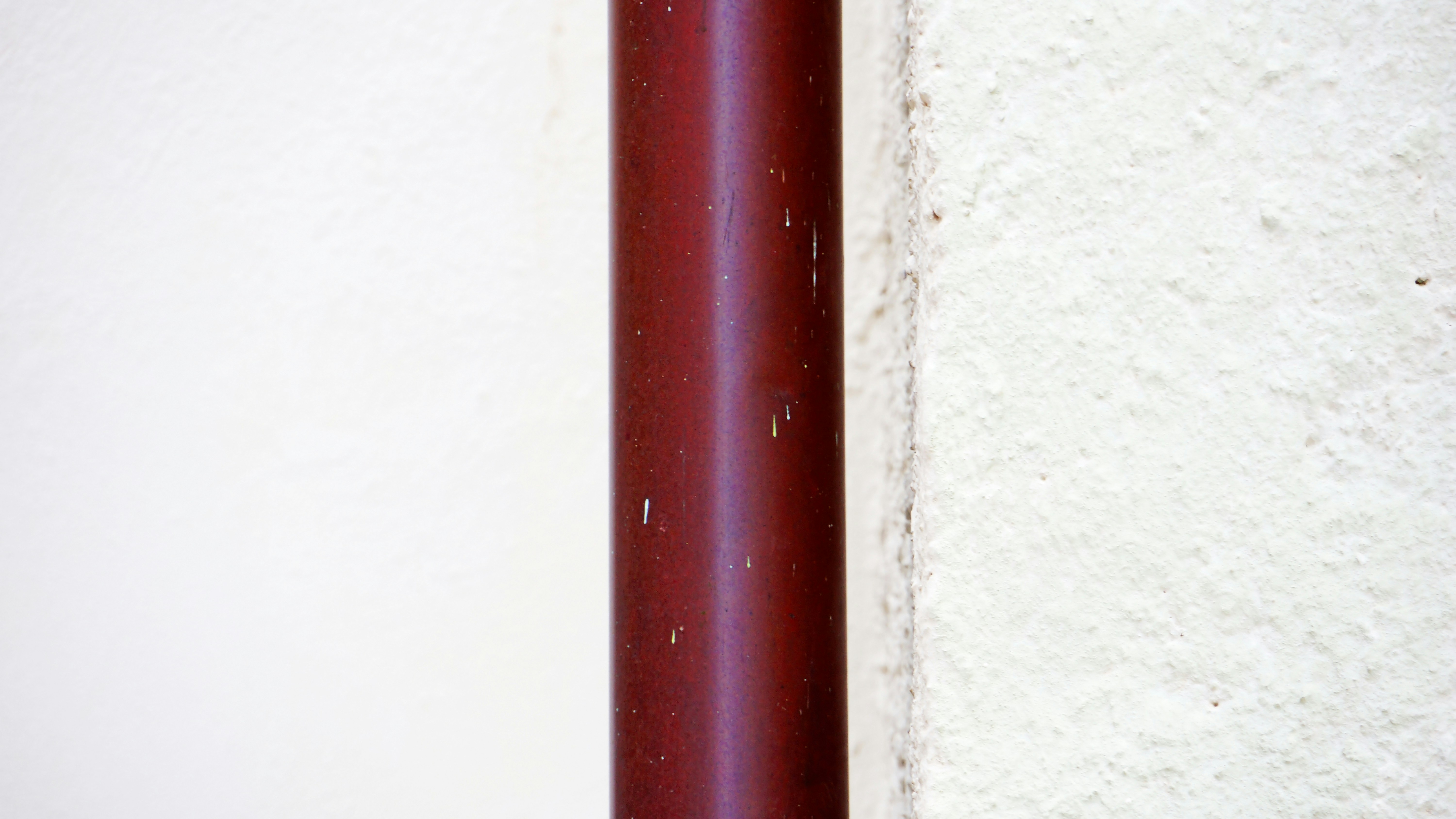 A close-up image of a corroded outdoor pipe against a weathered wall, illustrating the impact of salt air in a coastal environment. - best plumbing repair fort myers beach fl