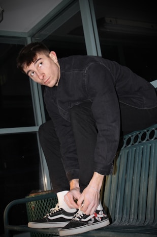 Young person tying their sneakers before heading out in an urban park.