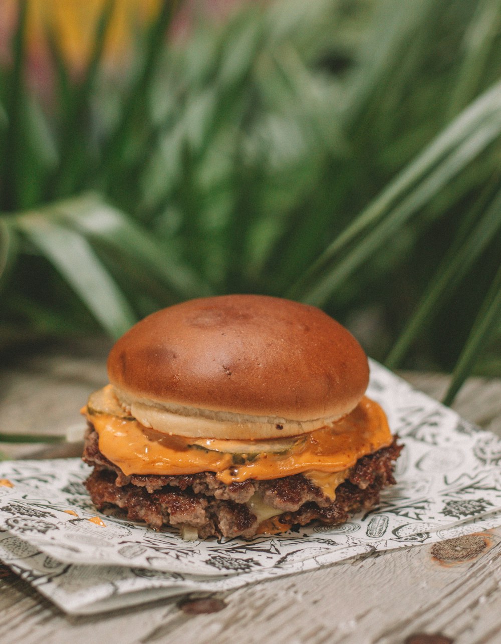 burger on white and red floral table cloth