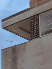 Close-up of clean building materials including concrete, glass, and brick surfaces.
