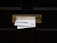A black door with a brass mail slot containing two pieces of mail. Above the slot, a sign reads 'No Free Newspapers or Junk Mail'. The mail is protruding from the slot and includes text and images of people.