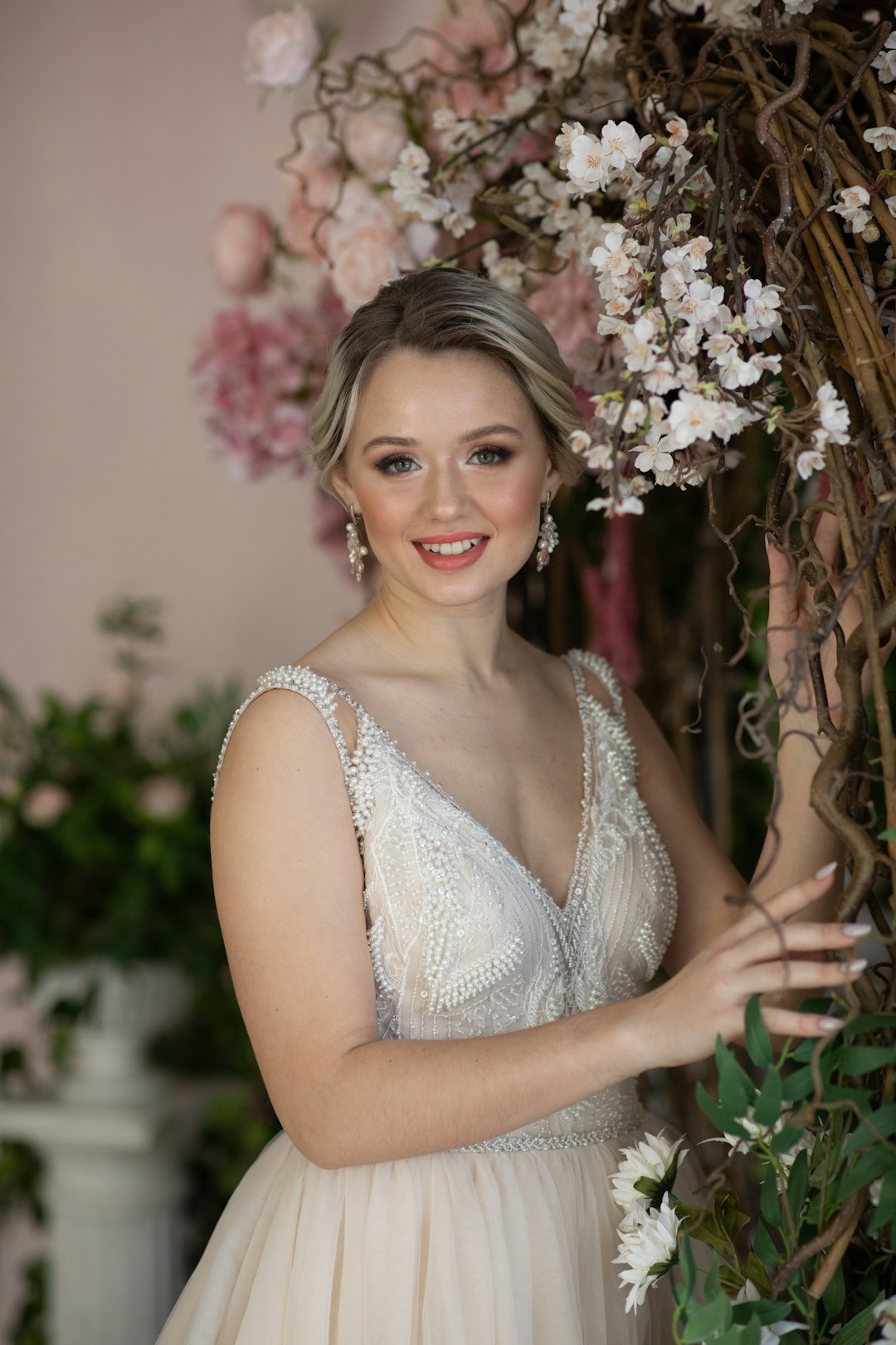 woman in white sleeveless dress smiling