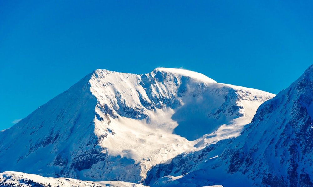 snow covered mountain under blue sky during daytime