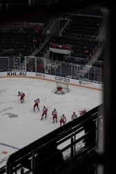 A small group practicing roller hockey drills on an outdoor rink.