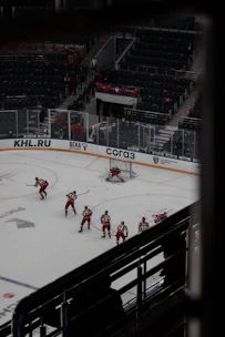 A small group practicing roller hockey drills on an outdoor rink.