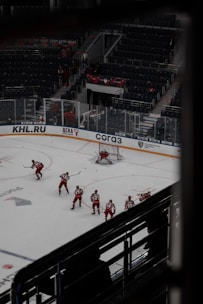 A small group practicing roller hockey drills on an outdoor rink.