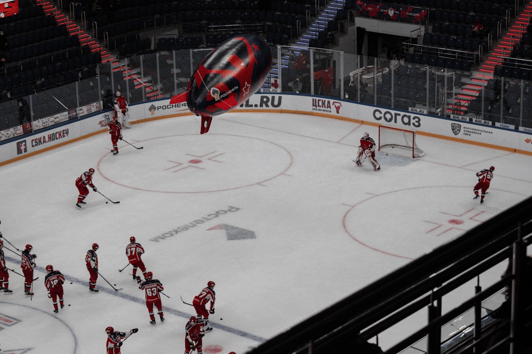 people playing ice hockey on ice stadium