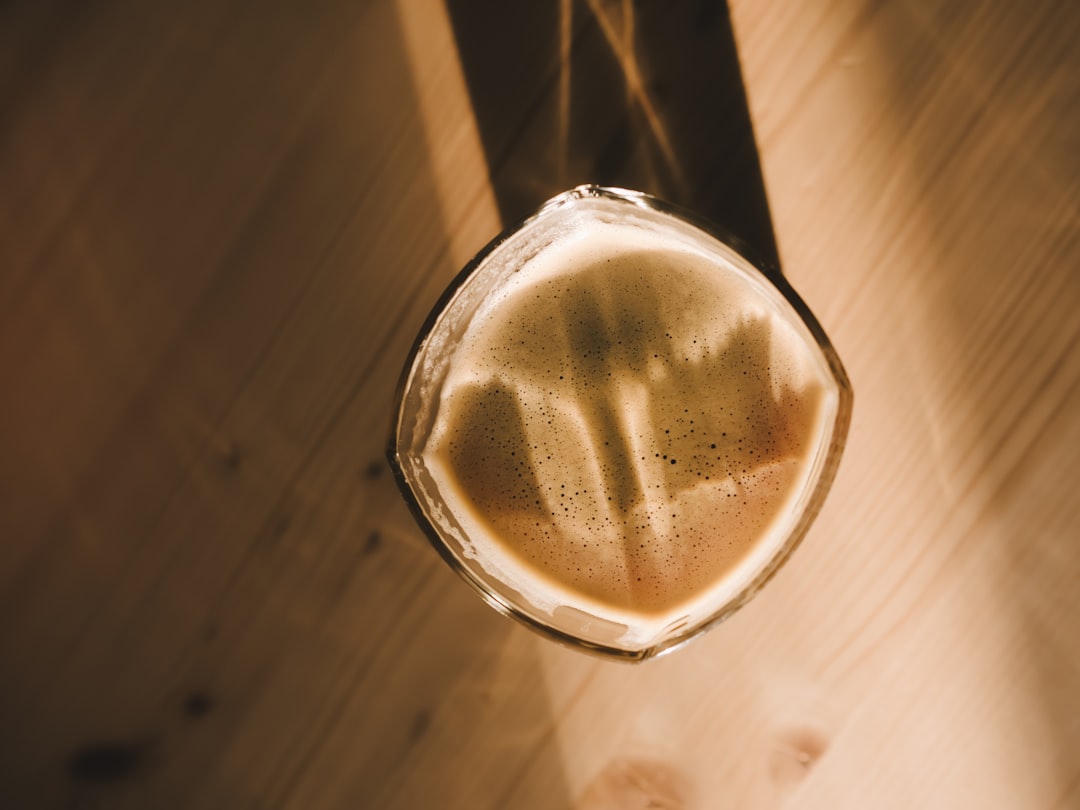 clear drinking glass with brown liquid