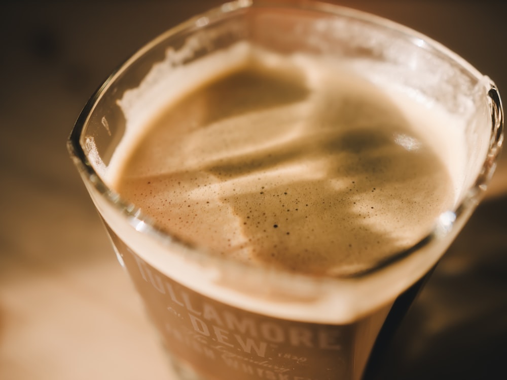 clear drinking glass with brown liquid