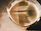 Close-up of a sleek espresso martini glass with a creamy froth and coffee beans on top.