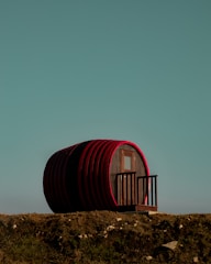A sturdy wooden rainwater collection barrel under a sloped roof.