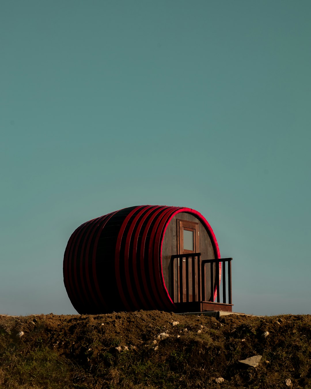 red and black tunnel on brown field during daytime