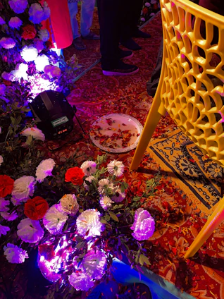 A vibrant event setup with elegant floral arrangements and joyful guests celebrating.