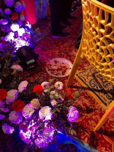 A vibrant party setup with colorful decorations and floral arrangements.