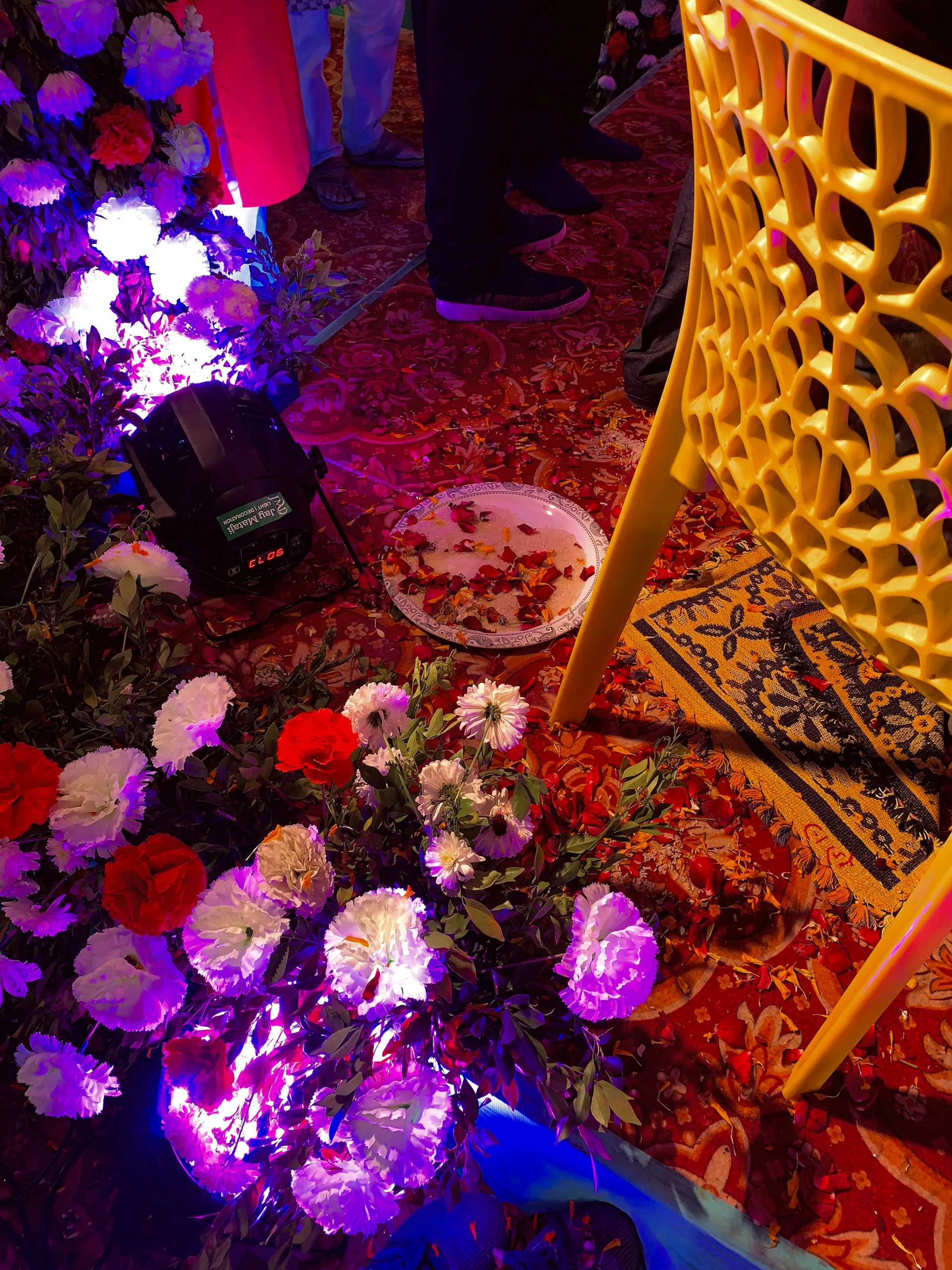 A sophisticated private celebration with sleek red and white décor, set against the warm tones of a Marrakech sunset, captured in natural light.
