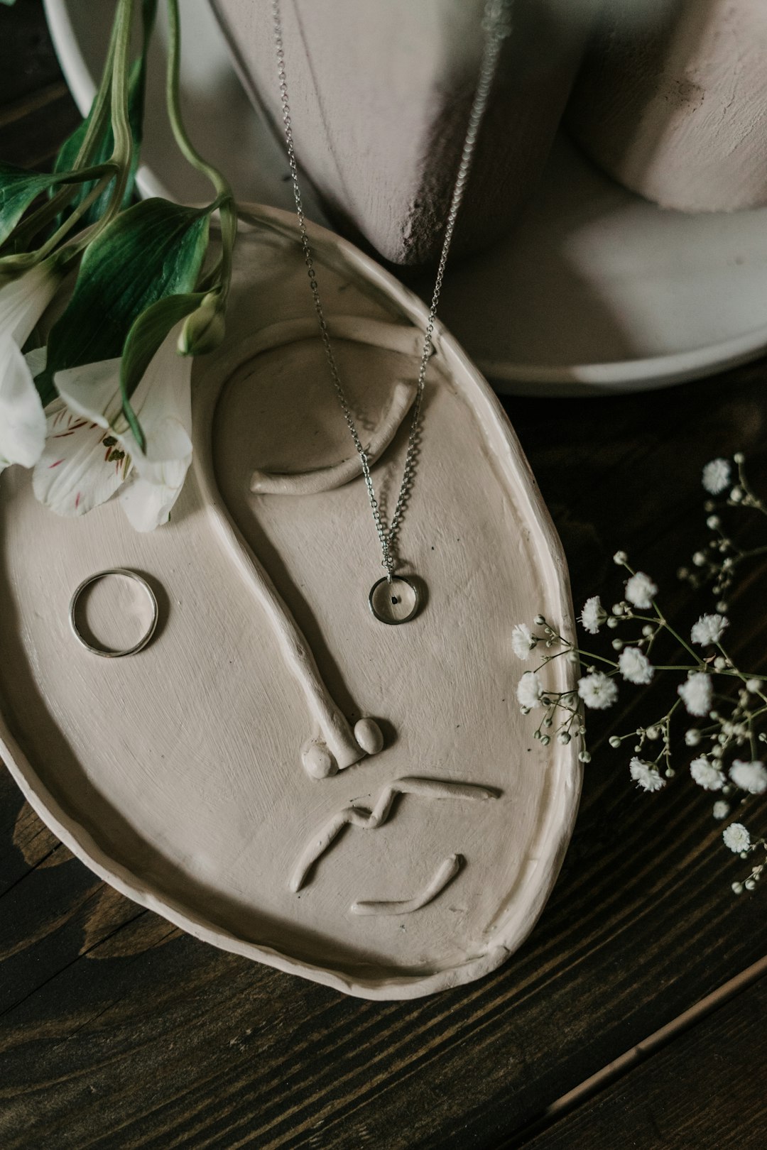 silver heart pendant necklace on brown wooden table