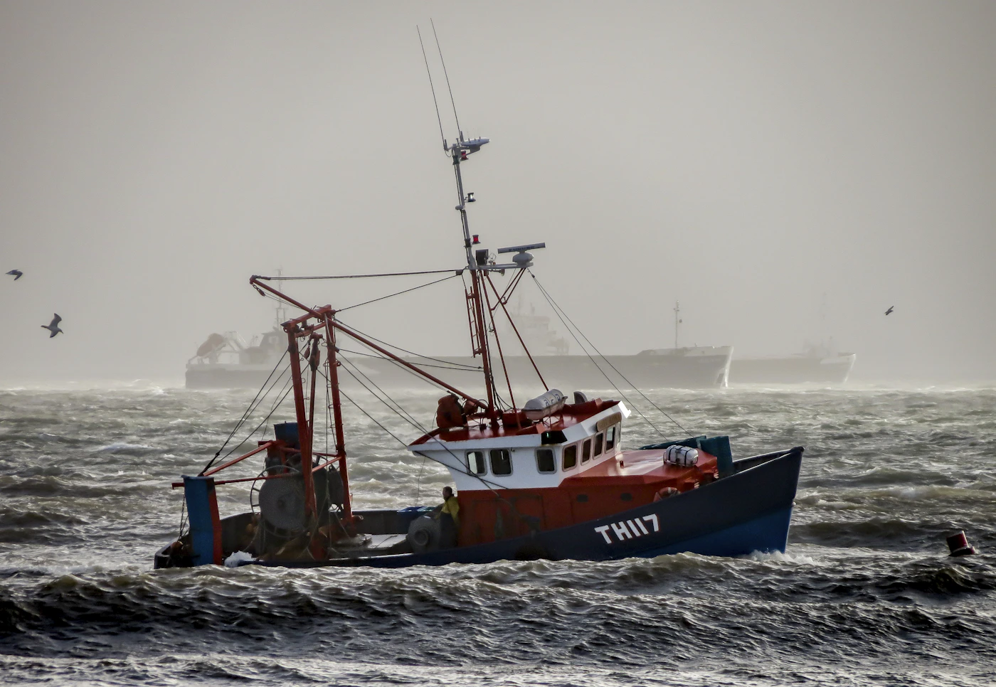 Commercial fishing vessel at sea representing the kind of vessels Jones Act seamen work on every day