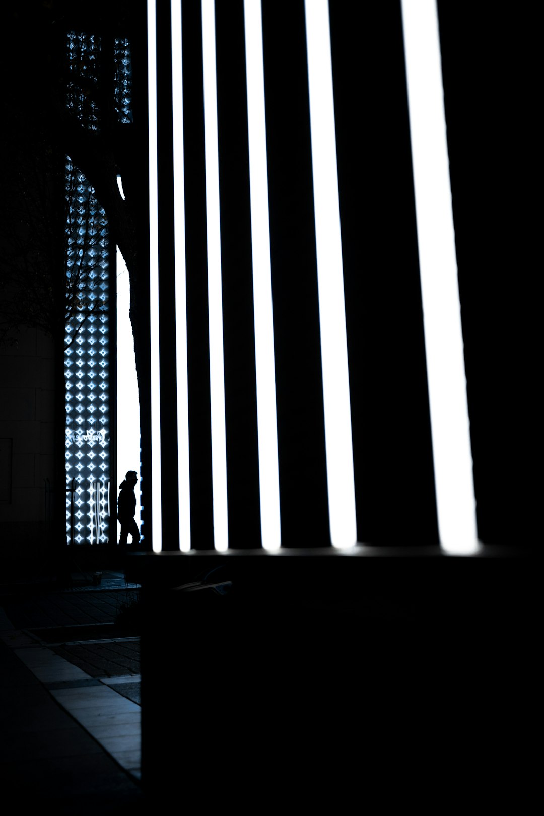 silhouette of person standing on window