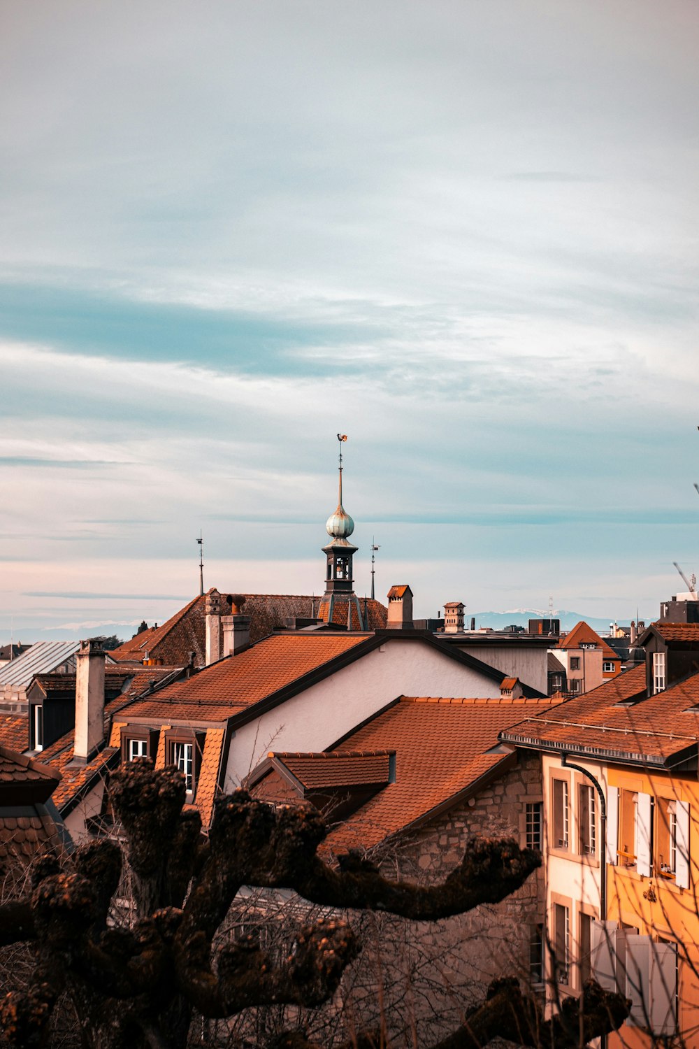 brown and white concrete houses under white clouds during daytime