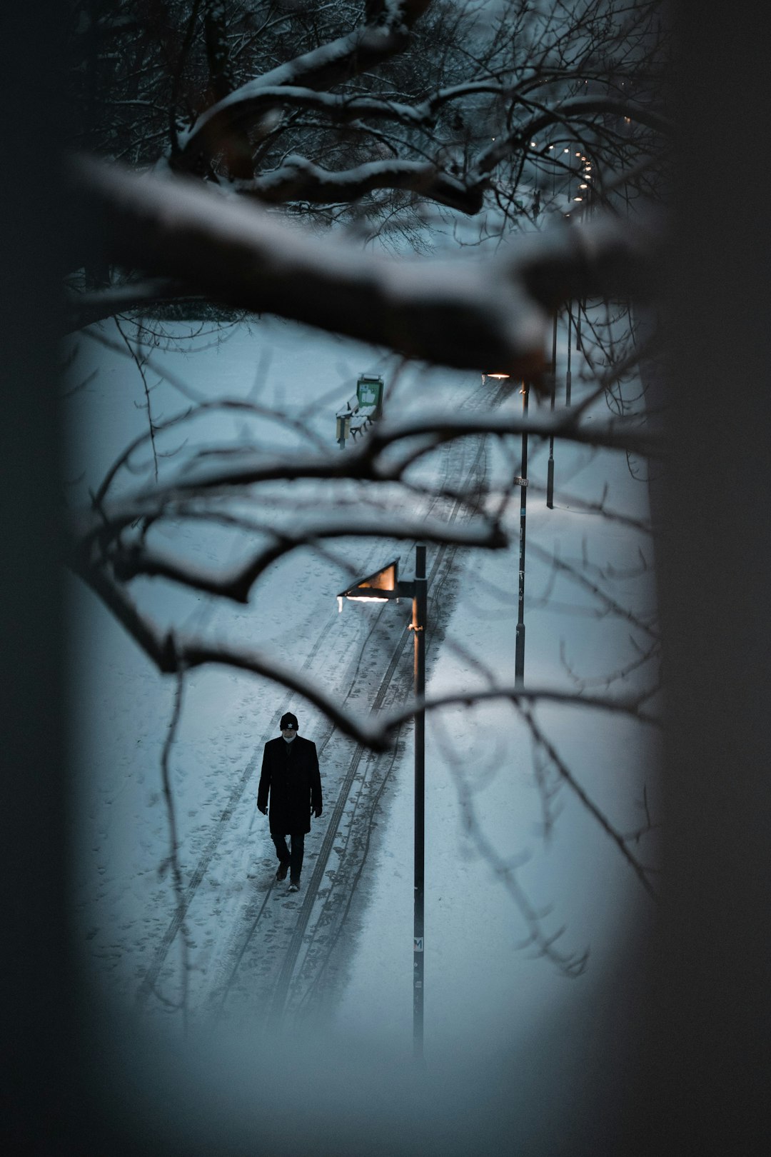 person in black jacket standing on snow covered ground