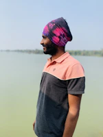 Photo of Tata, the team leader, standing by the shoreline with a relaxed, approachable demeanor